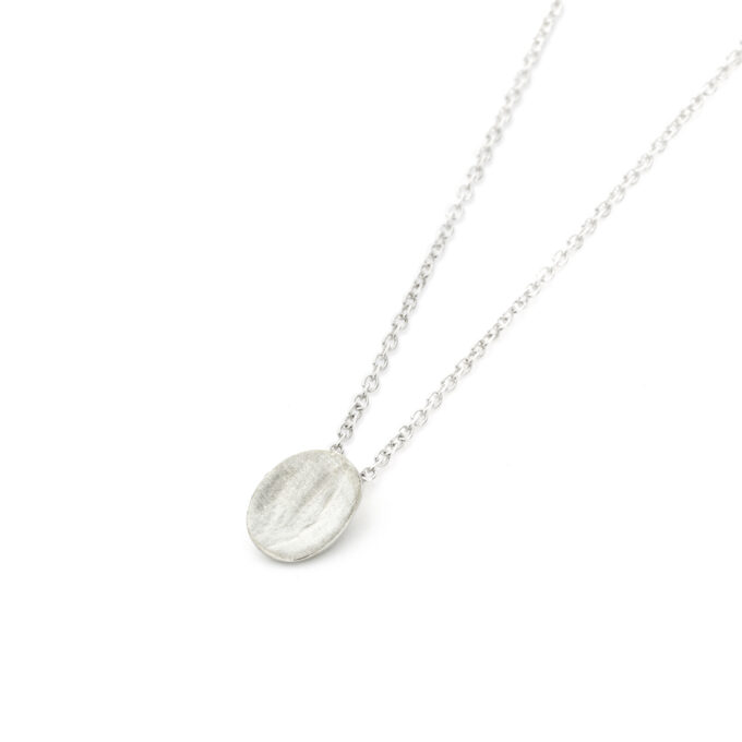 Minimalist oval necklace by Ines Bouwen Jewelry, handcrafted in white gold with a rhodium finish, displayed on a delicate chain.